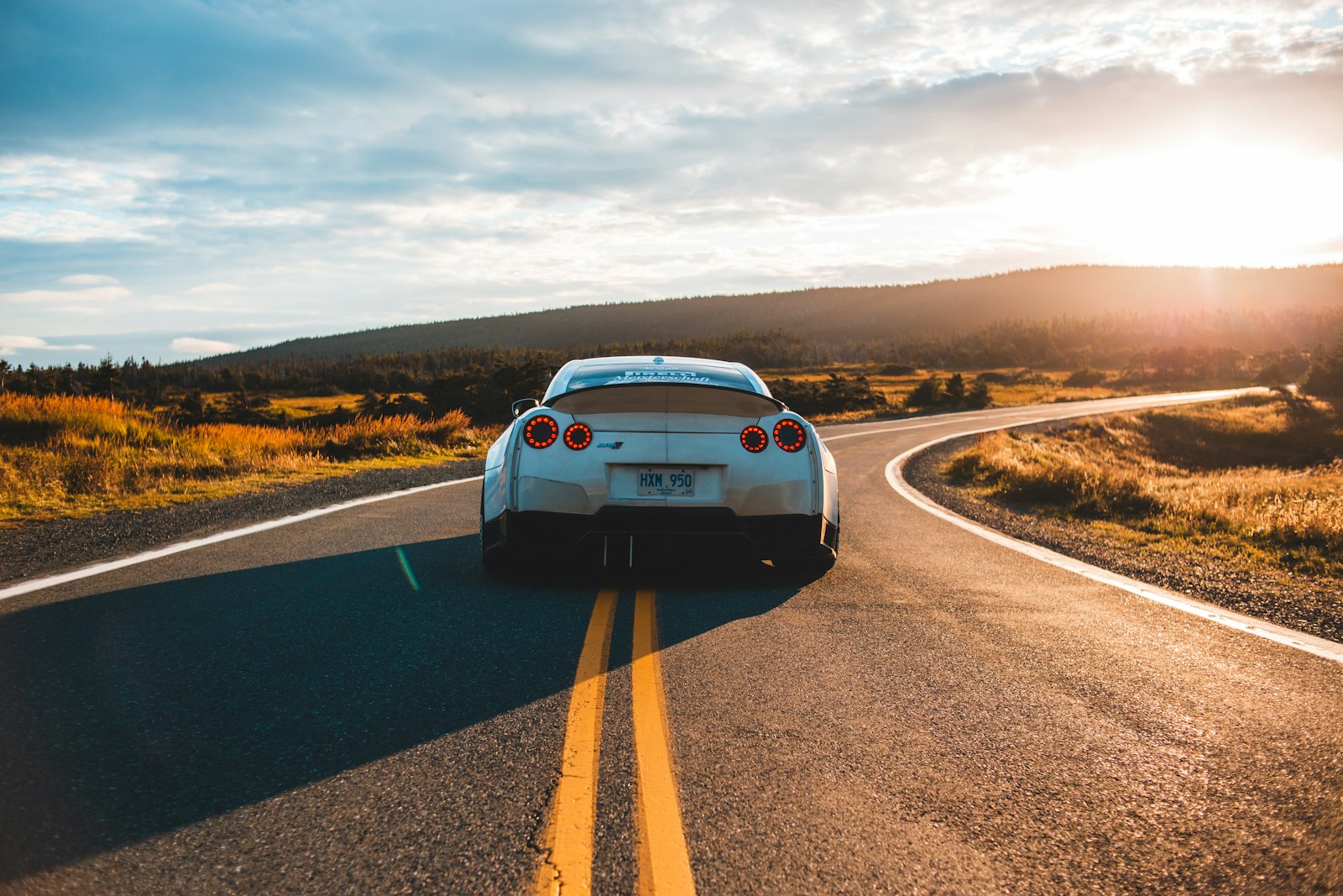 Car travelling on an open road representing foreign vehicle injury claims